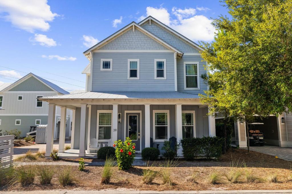 a blue house with white columns at Do Grayt Things by 30A Escapes in Grayton Beach