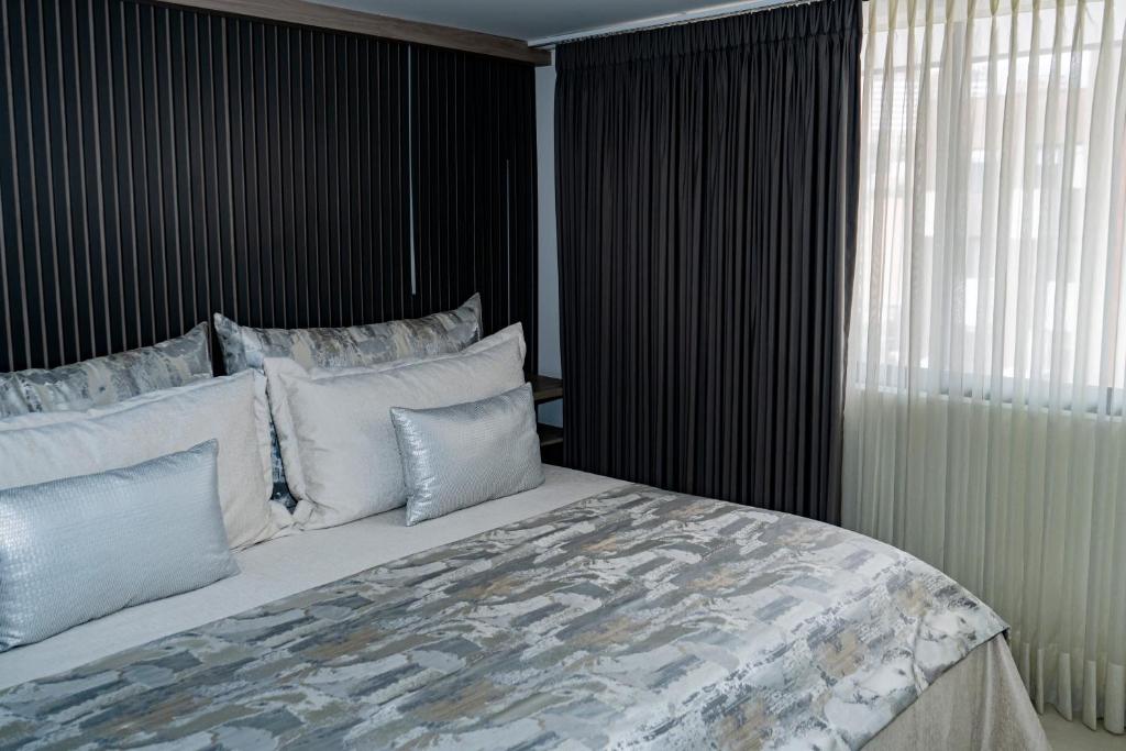 Postel nebo postele na pokoji v ubytování Apartamentos Gema Lujosos en Laureles