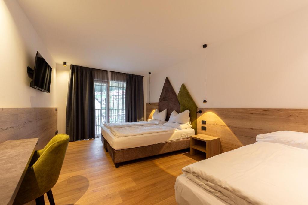 Postel nebo postele na pokoji v ubytování Monza Dolomites Hotel