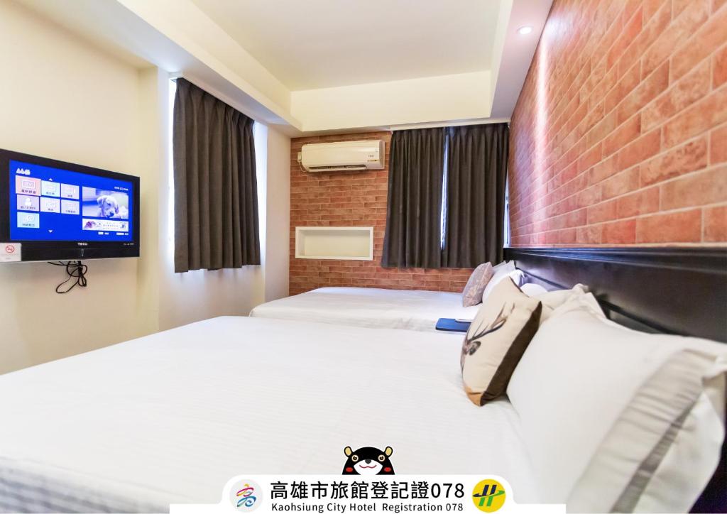 Postel nebo postele na pokoji v ubytování Newrise Hotel