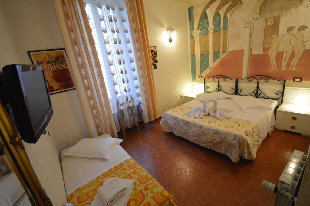 Postel nebo postele na pokoji v ubytování Hotel Alexis