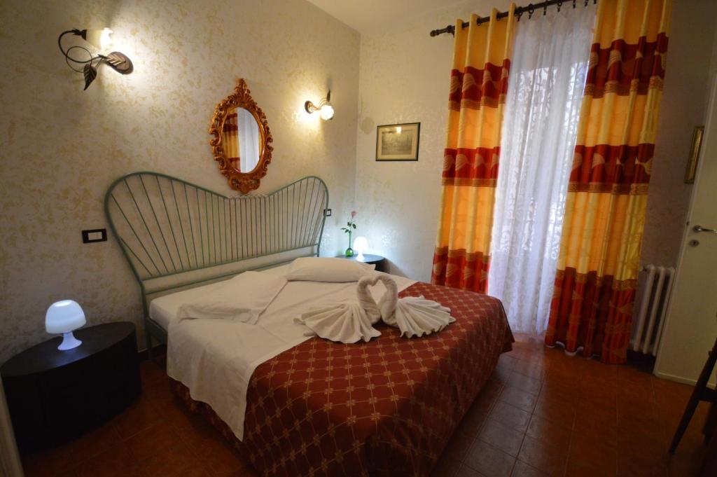 Postel nebo postele na pokoji v ubytování Hotel Alexis