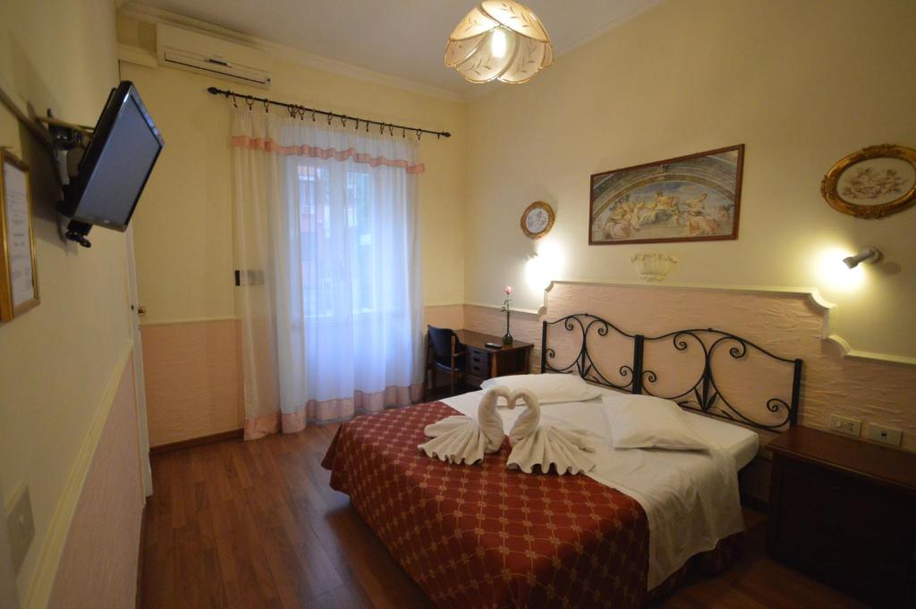 Postel nebo postele na pokoji v ubytování Hotel Alexis