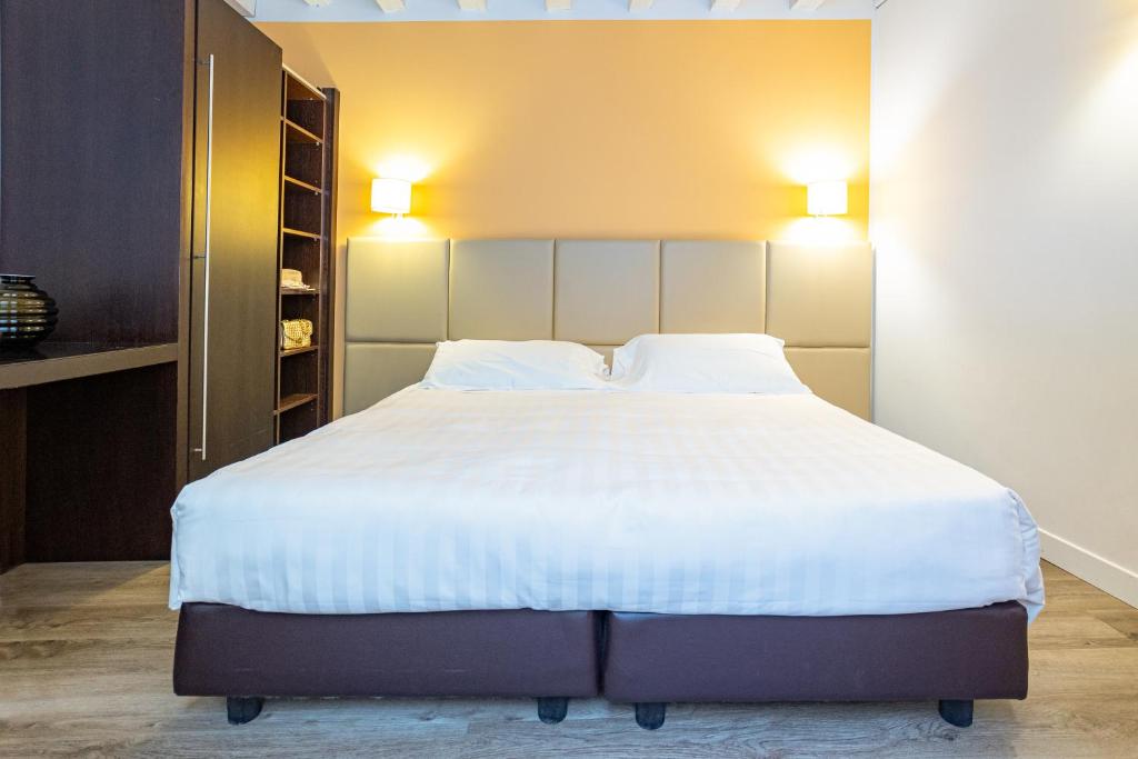 Postel nebo postele na pokoji v ubytování Relais Santa Corona