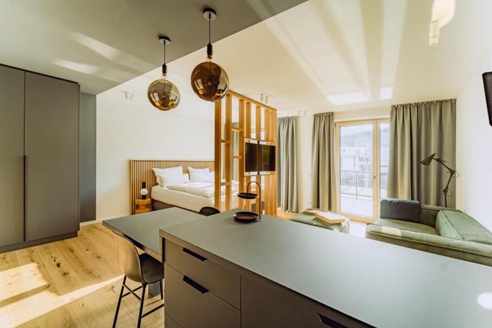 a large living room with a bed and a table at KABINETT Boutique Apartments in Kröv