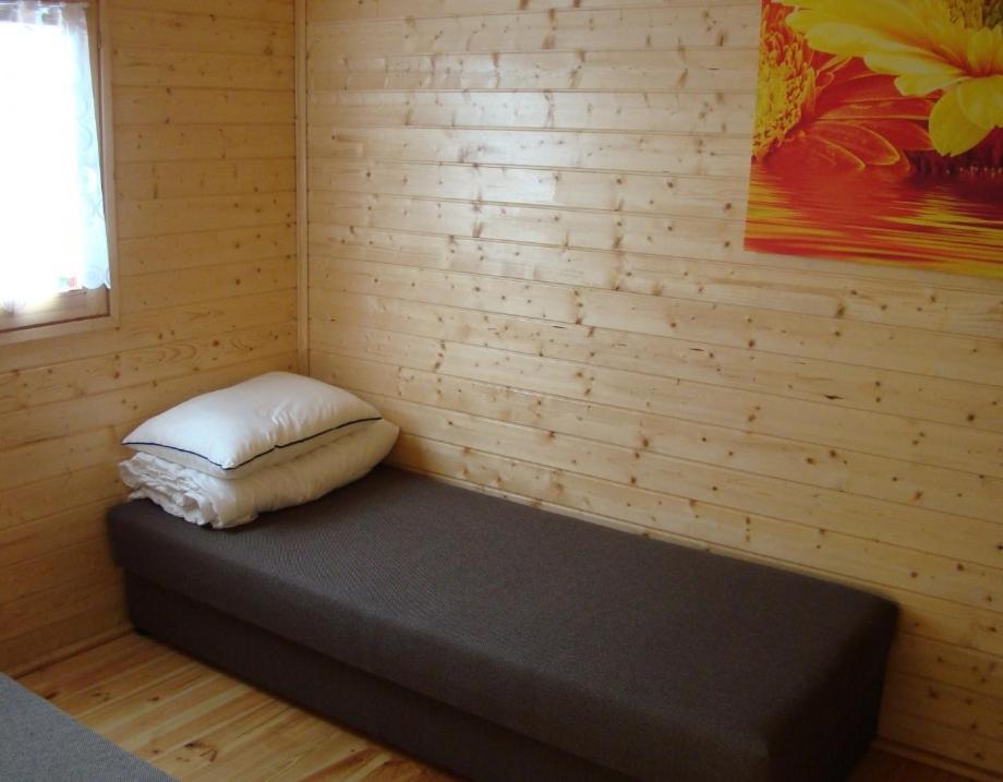 Posteľ alebo postele v izbe v ubytovaní Domki drewniane alpejskie