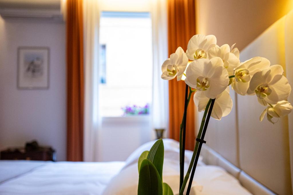 Postel nebo postele na pokoji v ubytování Relais Santa Corona