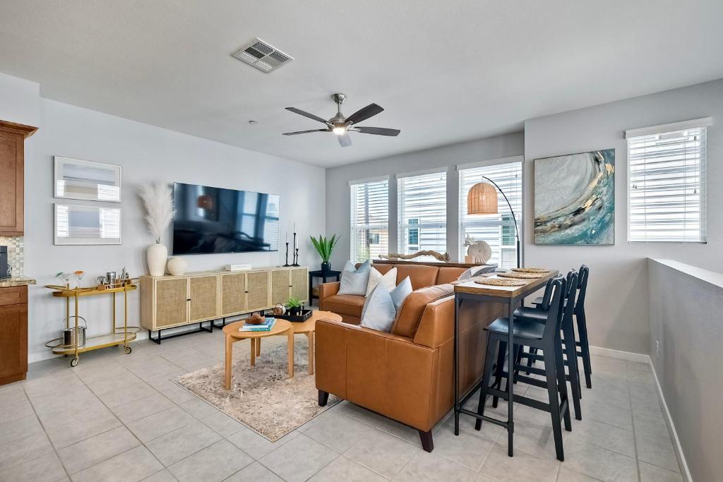 a living room with a couch and a table at Blocks To Beach - Coastal Beach Decor - Garage Parking - Gated Community - 30 Day Fully Furnished in Oceanside