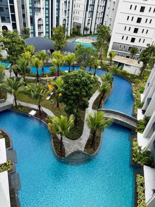 an overhead view of a pool with palm trees and buildings at Super Naiyang Title 1Bdr 600m to beach in Nai Yang Beach