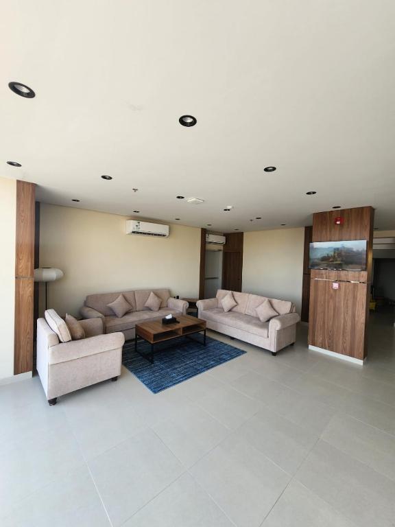 a living room with two couches and a coffee table at المهيدب للشقق الفندقية in Rabigh