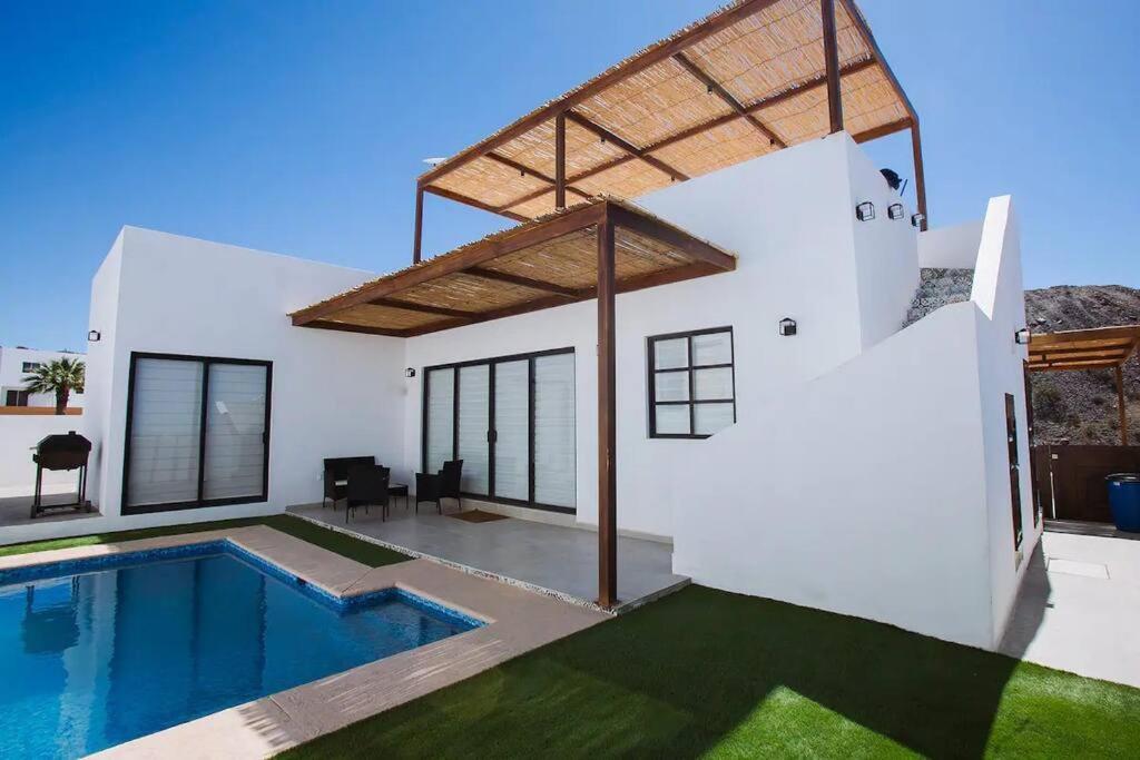 a villa with a swimming pool and a house at Exclusive pool house in Bahía Kino