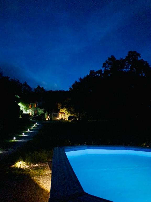 a swimming pool in the yard at night at Casa Vacanze Al Fontanile in Santa Fiora