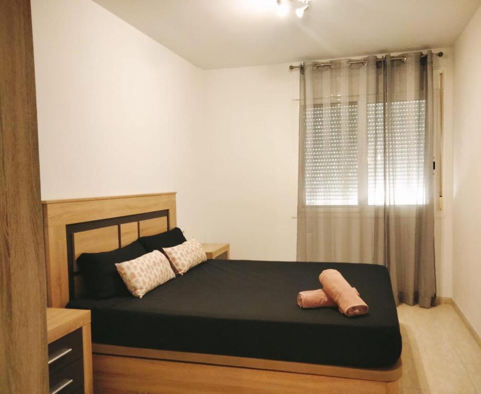 a bedroom with a bed with two towels on it at Apartamento en primera línea de mar!! in Alcanar