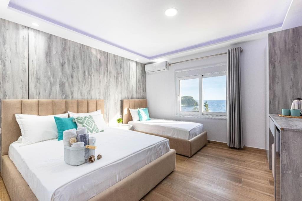 a bedroom with two beds and a window at Hi'Mare TOP Sea View 1 - Parking and Kitchen in Himare