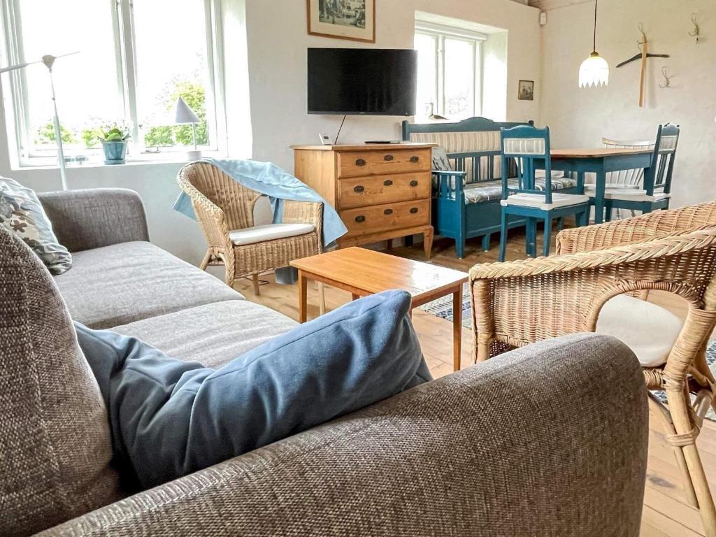 a living room with two couches and a dining room at Holiday home Löderup V in Löderup