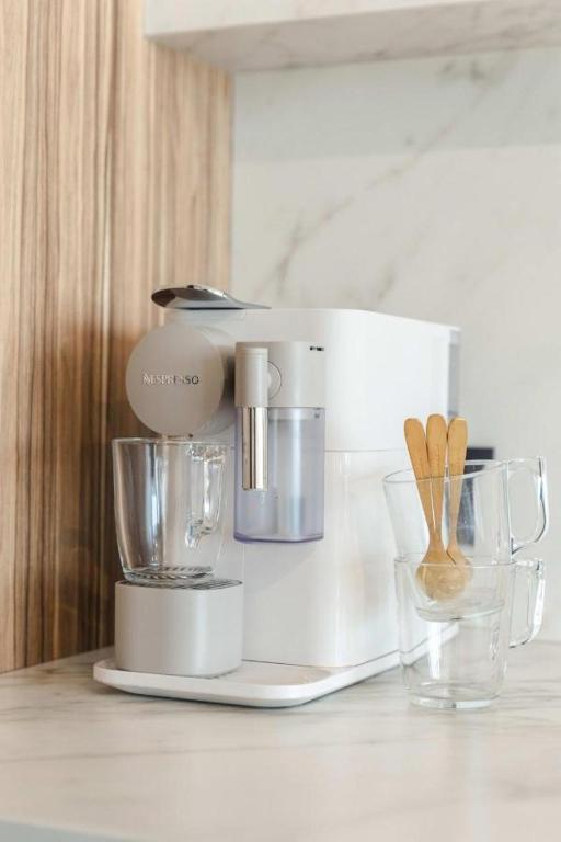 a kitchen counter with a mixer on a counter top at Wonderful architect designed flat with sea view in Ostend