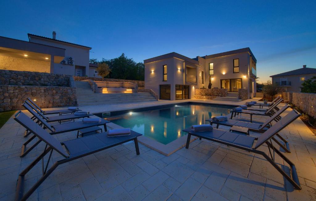 VrhにあるStunning Home In Vrh With Saunaのラウンジチェア付きのスイミングプール、家