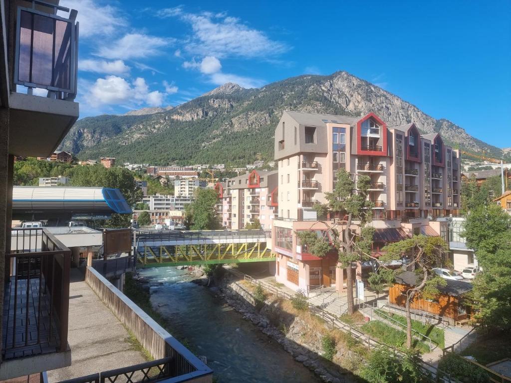 a view of a city with a river and buildings at Signal du Prorel Briançon Serre Chevalier "QOCLICO" in Briançon