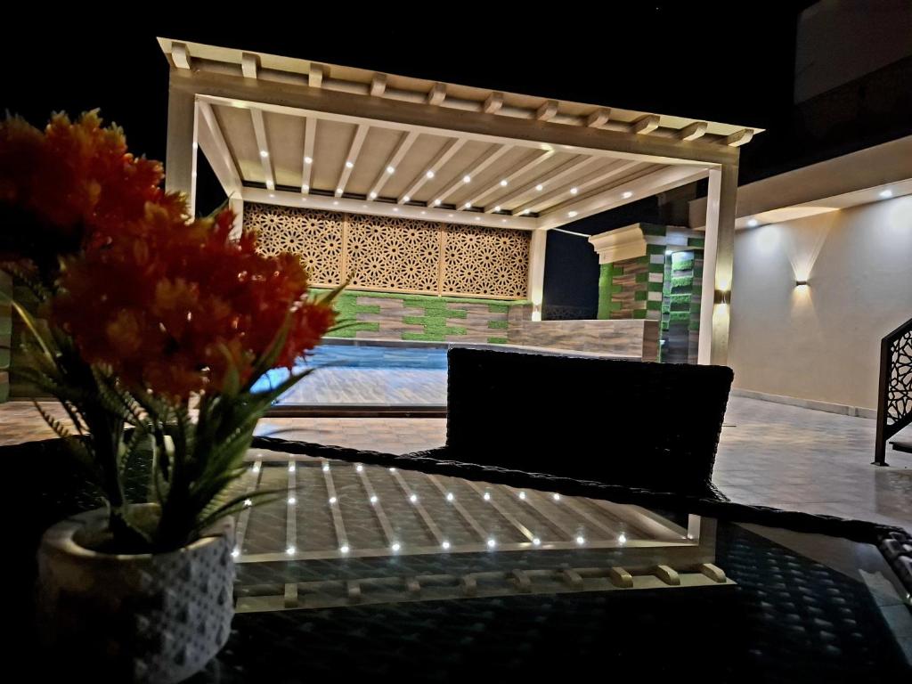 a table with a vase of flowers on it at Royal Galaxy Hotel & Residence - Near Islamabad International Airport & Motorway in Islamabad
