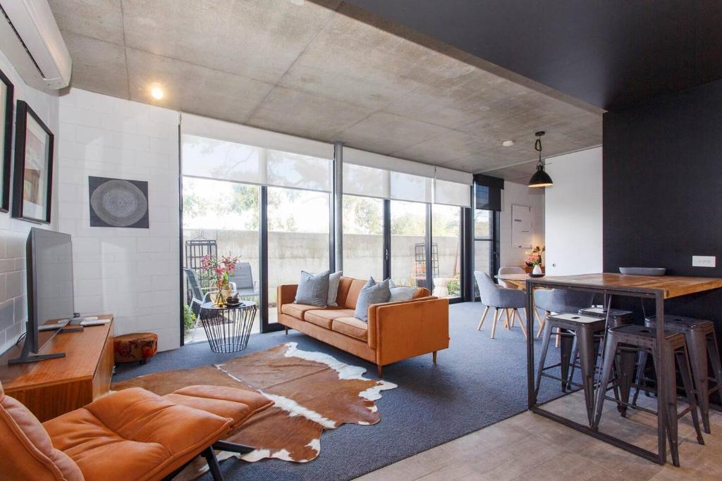 a living room with a couch and a table at Knutsford Modern New Winter Warmer in Fremantle