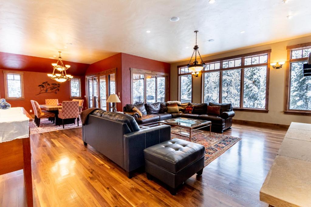 a living room with leather furniture and a table at 671 Elk Circle by Summit County Mountain Retreats in Keystone