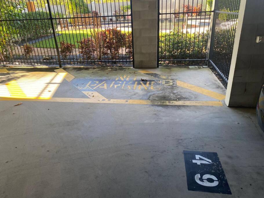 a parking sign on the ground next to a fence at Good Vibes Only on Stanley in Townsville