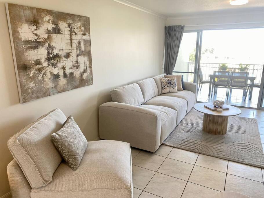 a living room with a couch and a table at Good Vibes Only on Stanley in Townsville