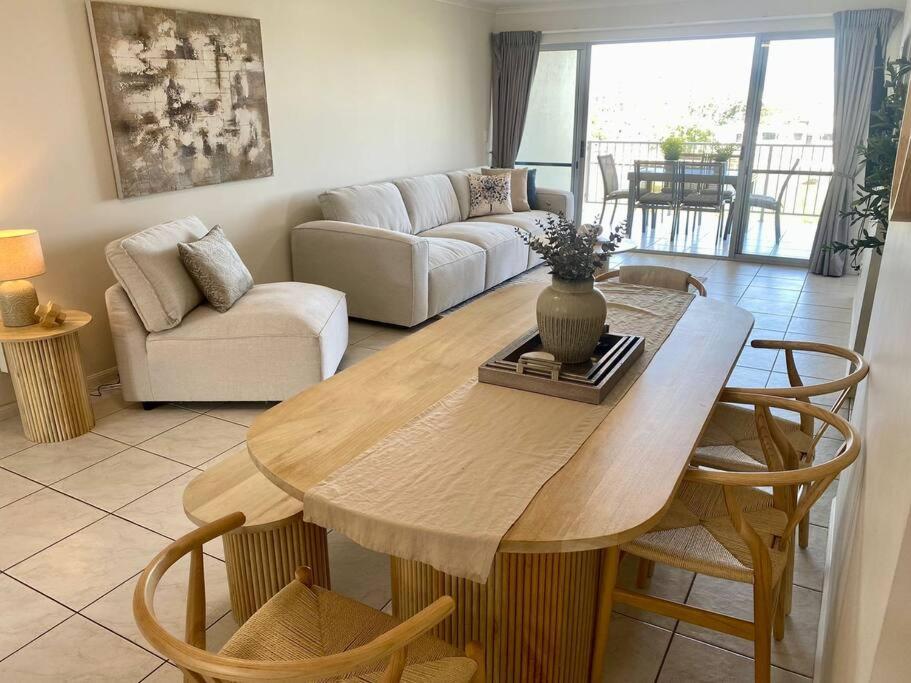a living room with a table and a couch at Good Vibes Only on Stanley in Townsville