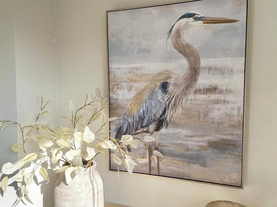 a painting of a bird on a wall at Good Vibes Only on Stanley in Townsville