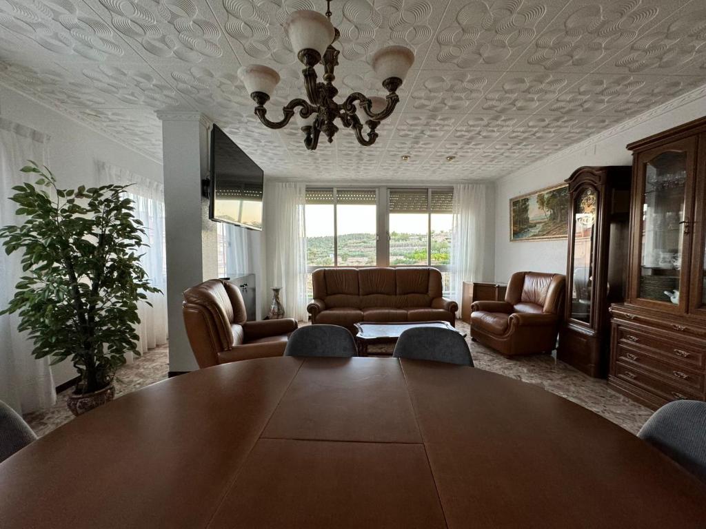 a living room with a large wooden table and leather chairs at Casa Rural Piker in Bolbaite