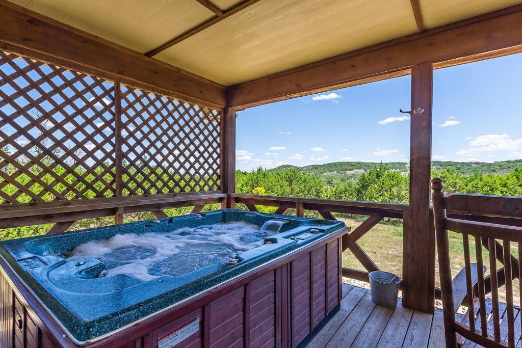 a jacuzzi tub on a wooden deck at Appian Way Oliva Cottage in Fredericksburg