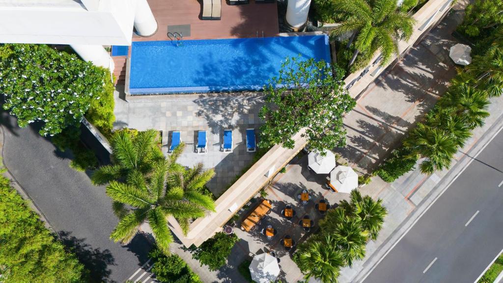 an overhead view of a pool and palm trees at InterContinental Residences Nha Trang by IHG in Nha Trang