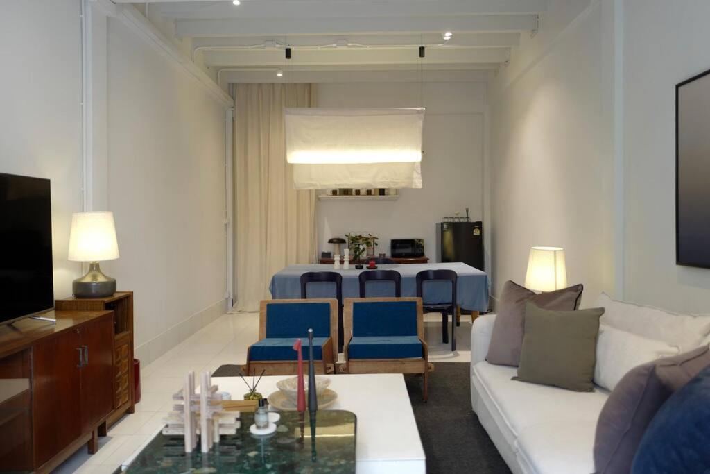 a living room with a couch and a table at Nap by Snooze in Bangkok