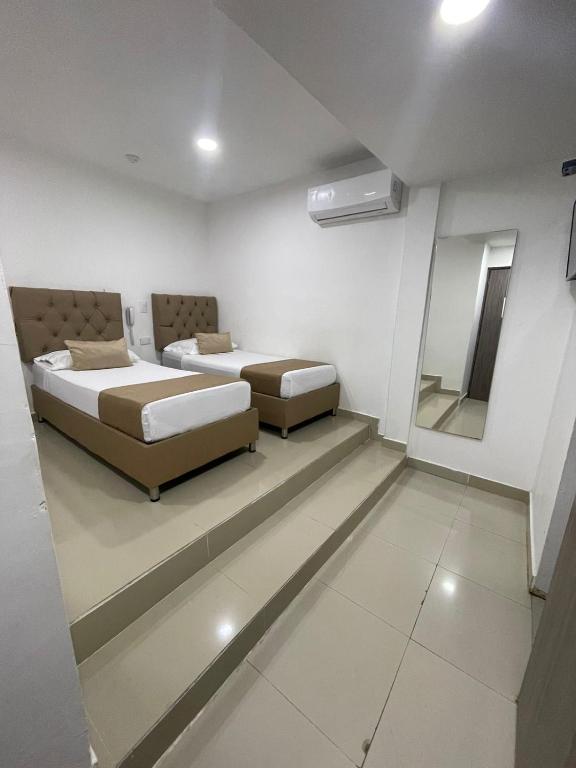 Postel nebo postele na pokoji v ubytování Hotel Hernández CTG
