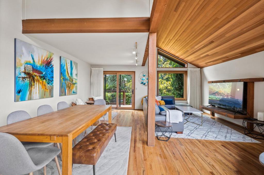 a living room with a wooden table and chairs at CapHill Charm in Seattle