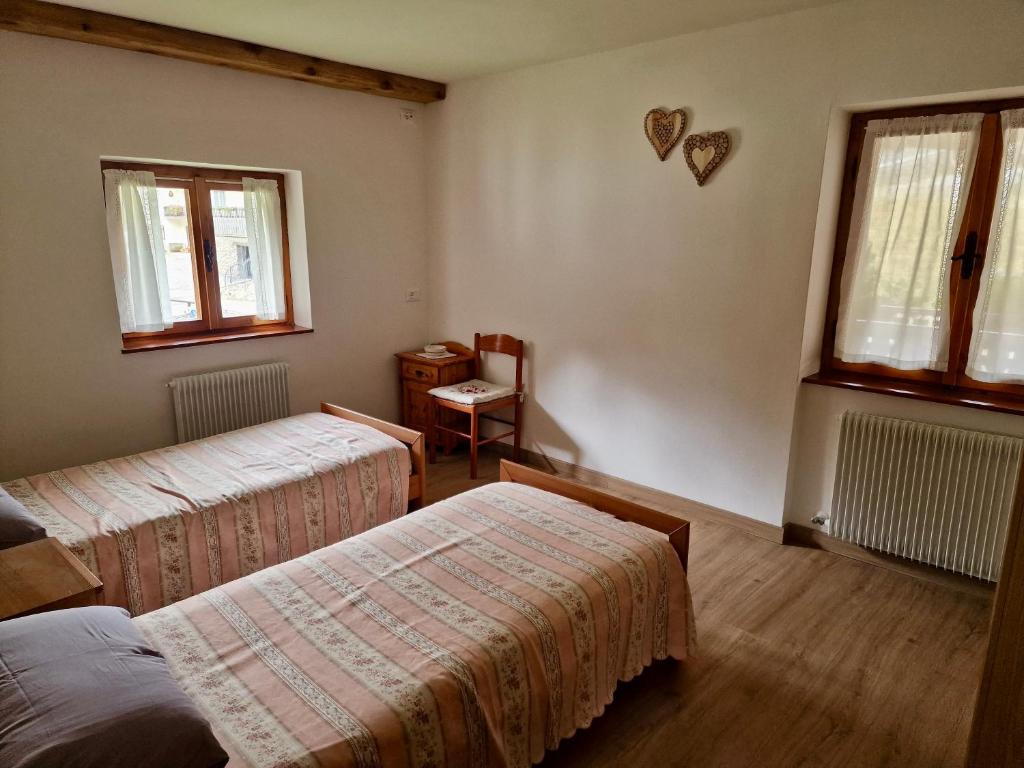 Postel nebo postele na pokoji v ubytování Chalet Nontiscordardime