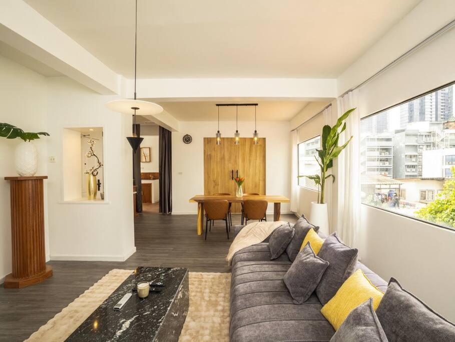 a living room with a couch and a table at 2-Bedroom Penthouse in the heart of Silom - 4A in Bang Rak
