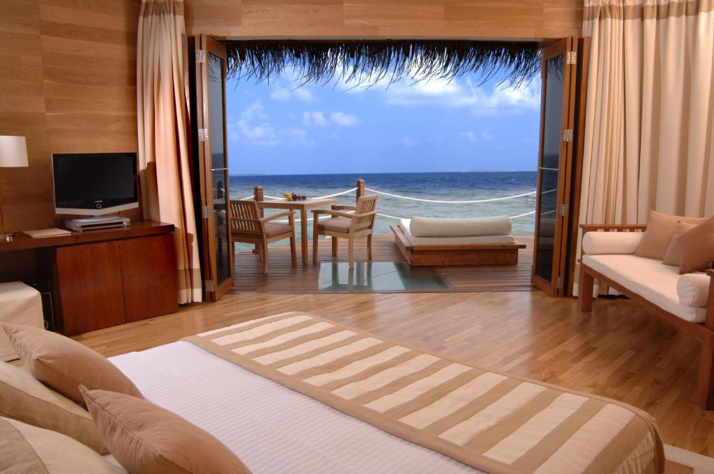 a hotel room with a view of the ocean at Adaaran Prestige Water Villas - with Dine around Premium All inclusive - 24 hours in Raa Atoll