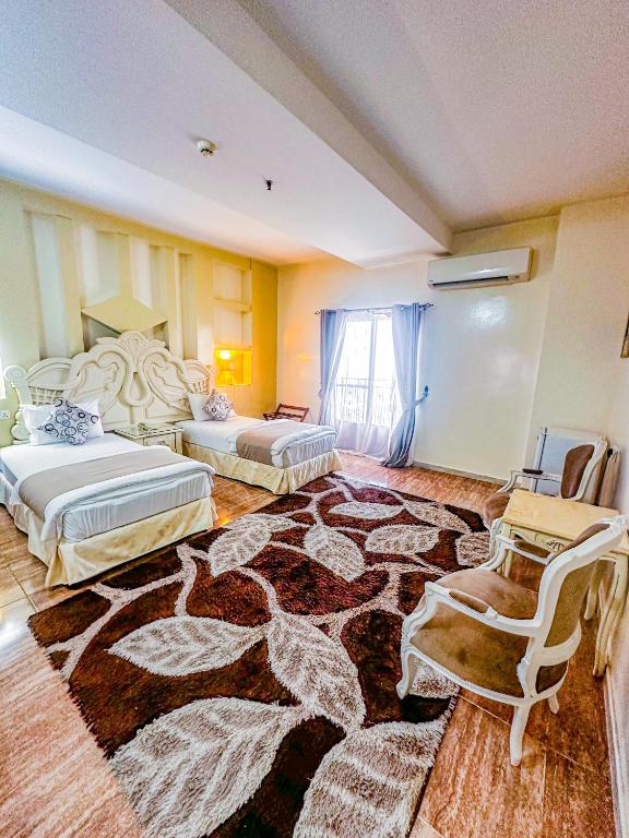 Postel nebo postele na pokoji v ubytování Riyam Hotel