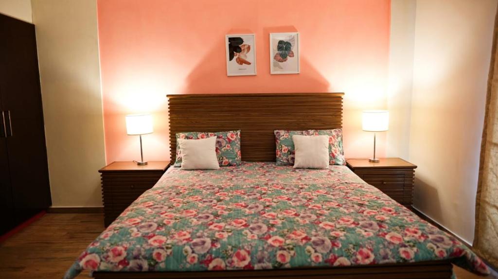 a bedroom with a large bed with two lamps at Fully furnished 1BHK, Bahria heights 1 in Rawalpindi