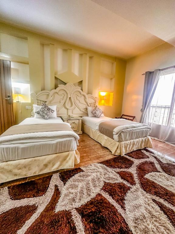 Postel nebo postele na pokoji v ubytování Riyam Hotel