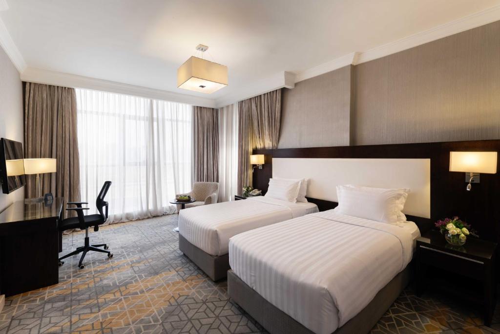 Postel nebo postele na pokoji v ubytování Warwick Hotel Jeddah
