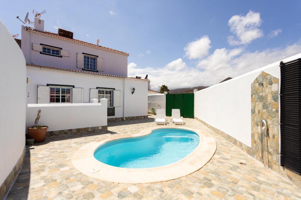 a swimming pool in the backyard of a house at Abades Private Pool By Sunkeyrents in Abades