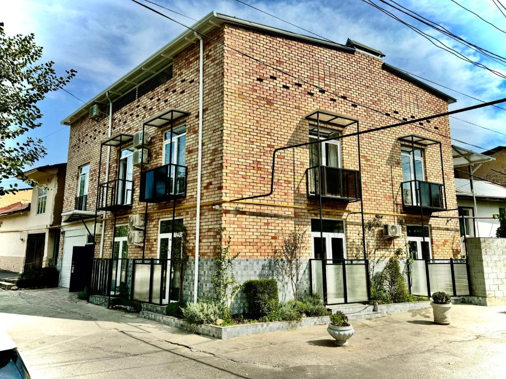 a brick building with windows and balconies on it at Samdarvoza in Tashkent