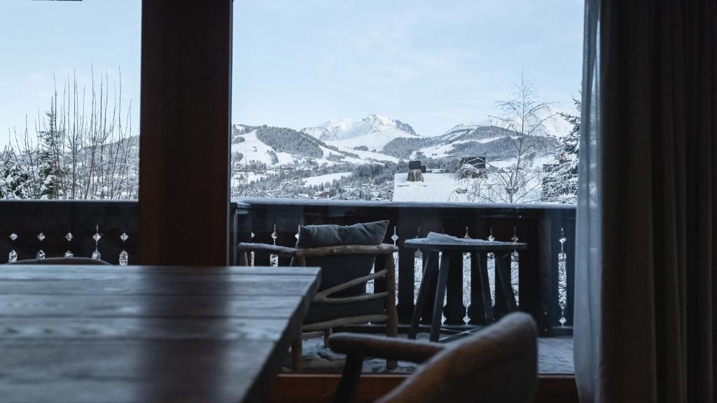 a view of a table and chairs from a window at L'Alpaga, a Beaumier hotel in Megève
