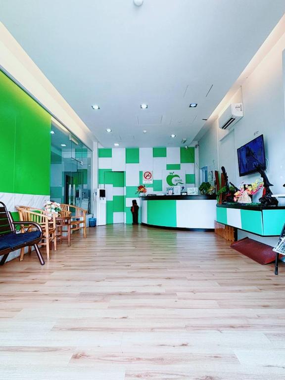 a lobby with a green and white wall at Asia Green Hotel in Sungai Besar