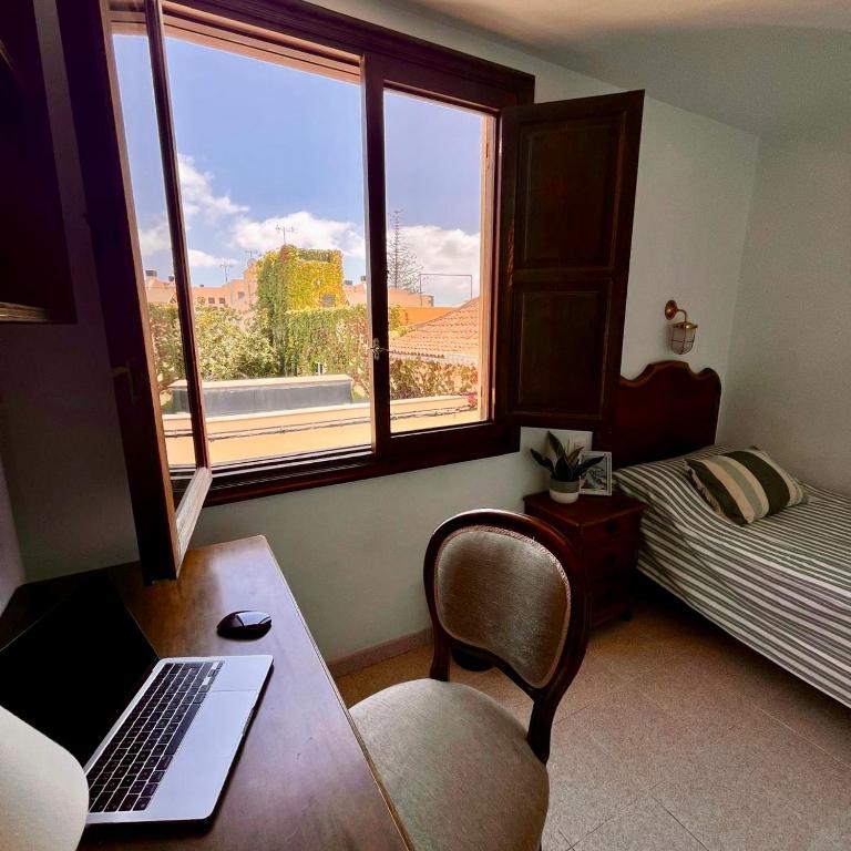 a room with a desk with a laptop and a window at Zen Den Coliving - For Digital Nomads Only in Arona