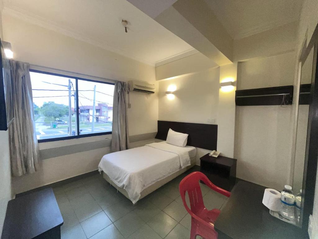 Postel nebo postele na pokoji v ubytování Hotel Sitiawan