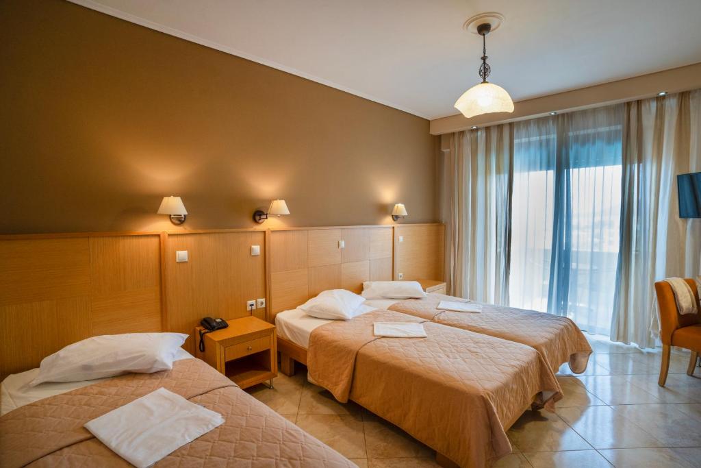 Postel nebo postele na pokoji v ubytování Evia Hotel & Suites