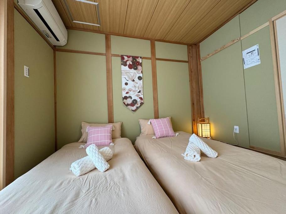 Postel nebo postele na pokoji v ubytování 木香の家-天下茶屋